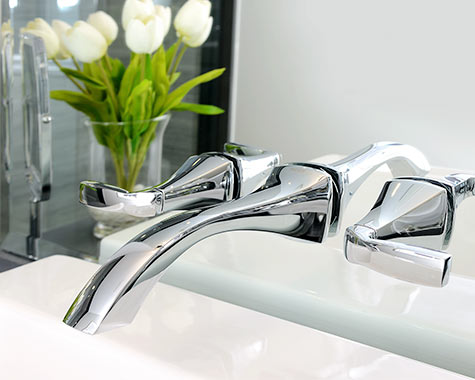 bathroom sink faucet coming through mirror