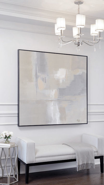 neutral colour wall art in a hallway above a bench